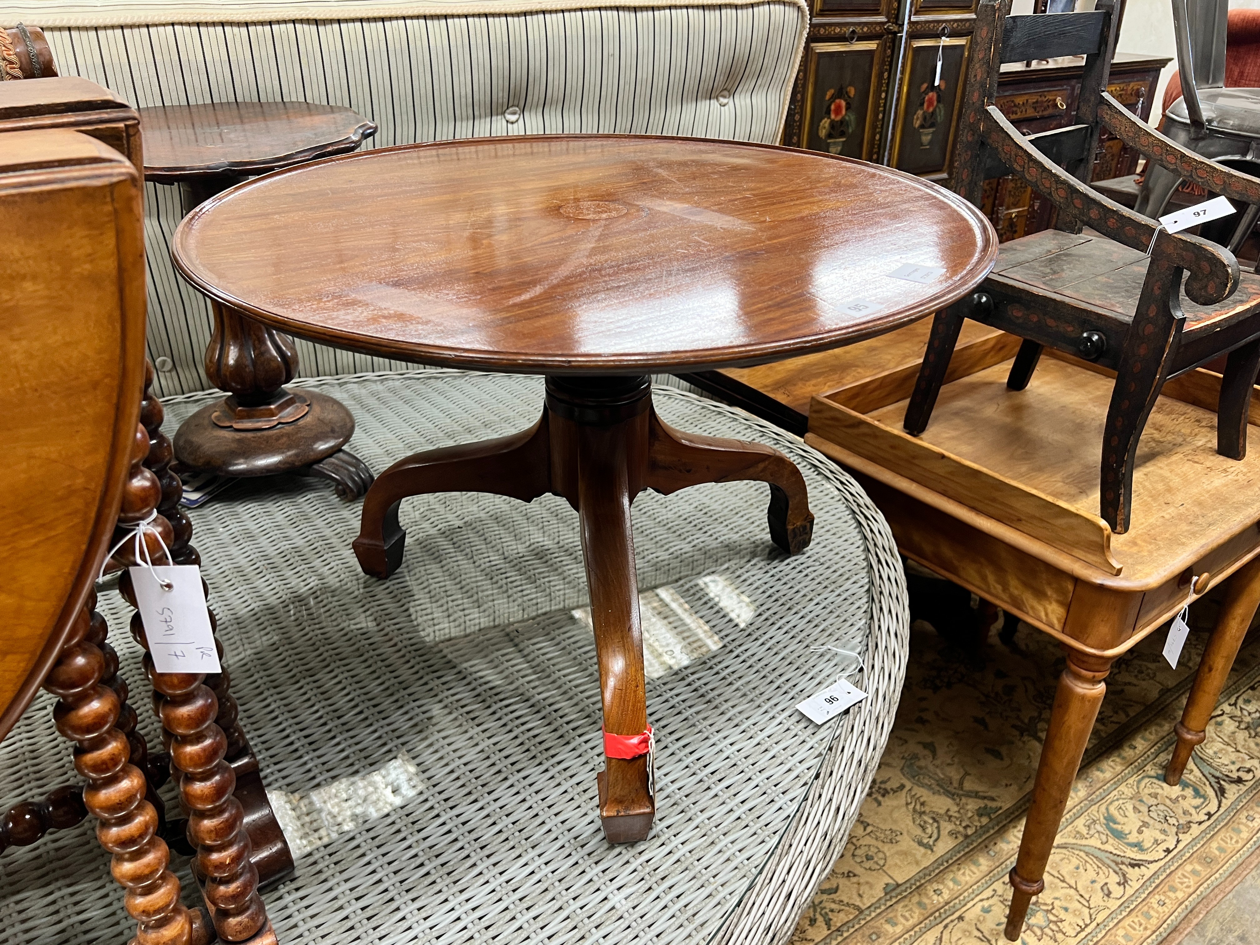 An early Victorian mahogany dish top tea table, diameter 69cm, height 47cm (cut down, converted from a dumb waiter) and a Victorian Sutherland table, width 55cm, depth 16cm, height 63cm